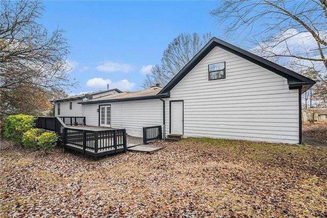 back of property with a wooden deck