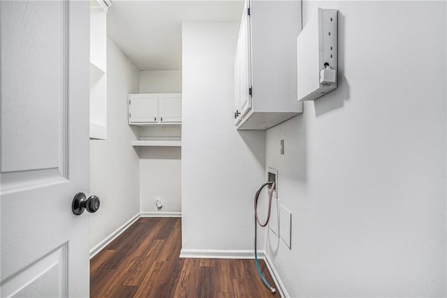 laundry area featuring washer hookup, dark wood-style flooring, cabinet space, and baseboards