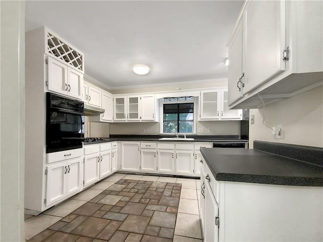 kitchen with black oven, sink, gas stovetop, and white cabinetry