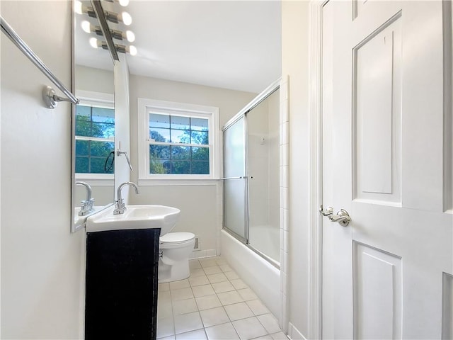 full bathroom featuring bath / shower combo with glass door, vanity, tile patterned flooring, and toilet