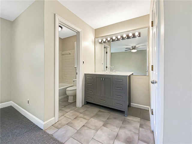 full bathroom with tile patterned flooring, tiled shower / bath combo, vanity, and toilet