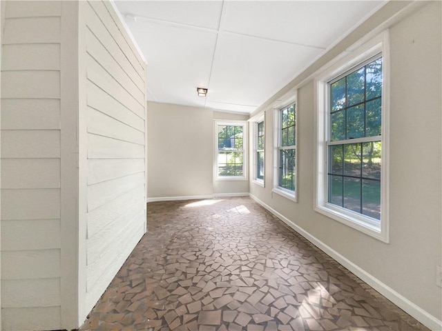 empty room featuring vaulted ceiling