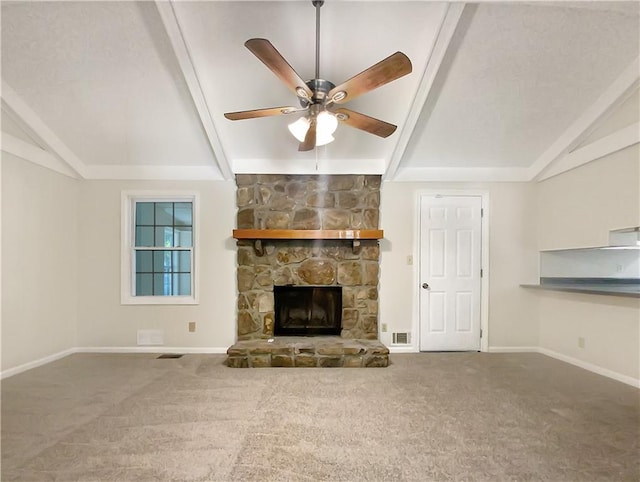 unfurnished living room with carpet floors, ceiling fan, lofted ceiling with beams, and a stone fireplace