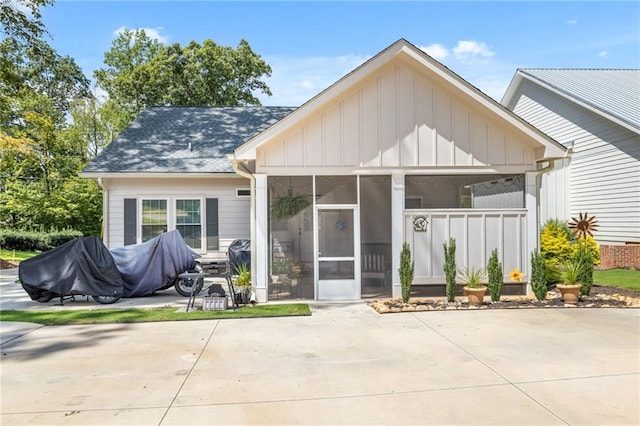 back of house featuring a patio and a sunroom