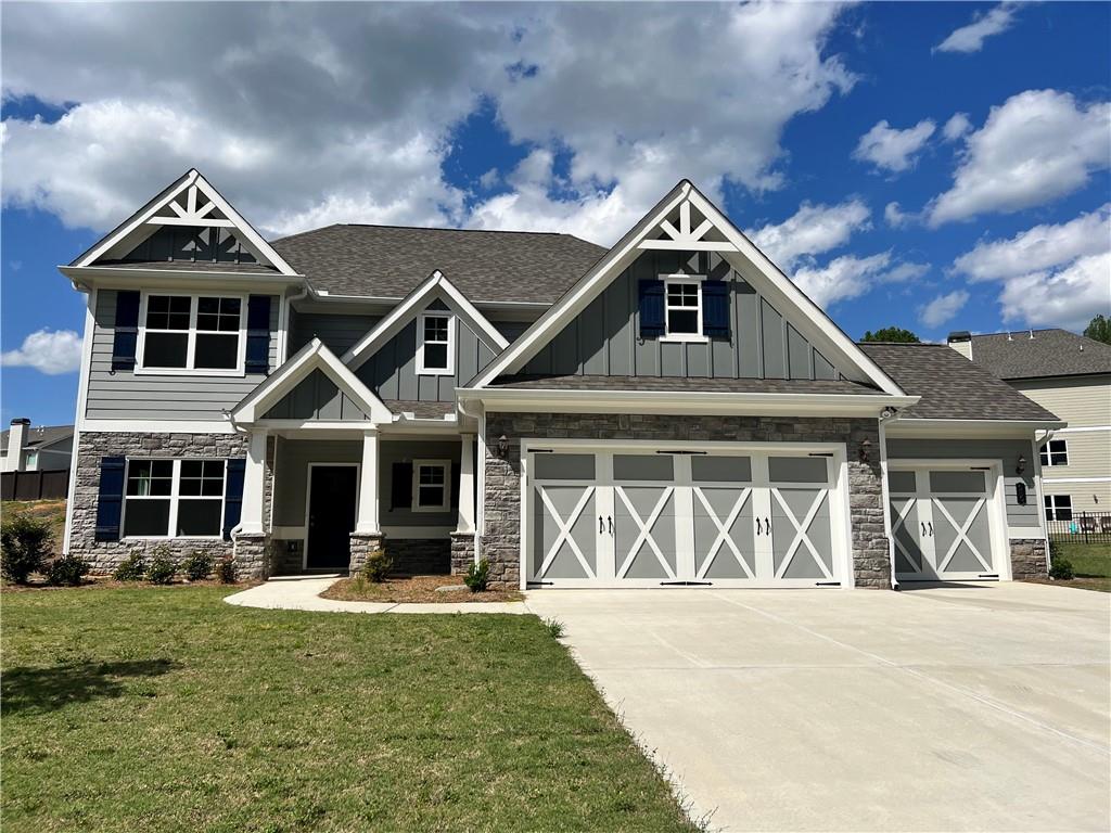 craftsman-style house with a front yard and a garage