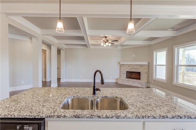 kitchen with coffered ceiling, decorative light fixtures, ceiling fan, and sink