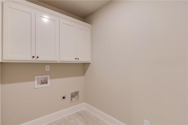 laundry room featuring cabinets, electric dryer hookup, washer hookup, and light tile floors