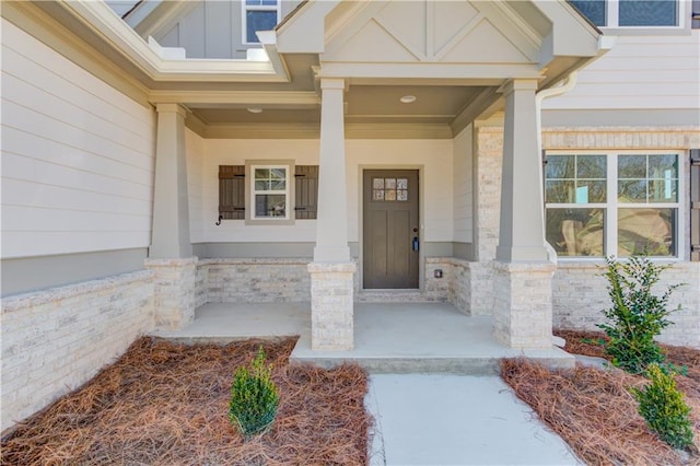 view of exterior entry with a porch