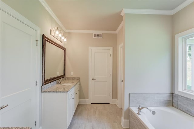 bathroom with hardwood / wood-style floors, ornamental molding, a relaxing tiled bath, and large vanity