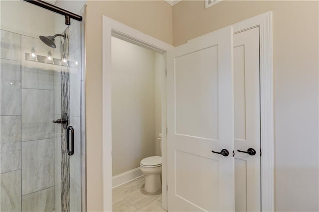 bathroom featuring an enclosed shower, tile floors, and toilet