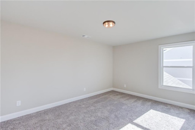 unfurnished room with light carpet