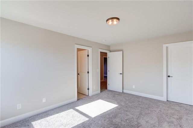 unfurnished bedroom featuring light carpet