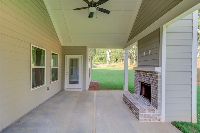 view of patio / terrace with an outdoor brick fireplace and ceiling fan