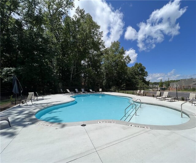 view of swimming pool featuring a patio