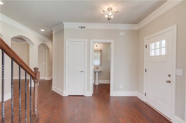 entryway featuring dark hardwood / wood-style floors and ornamental molding