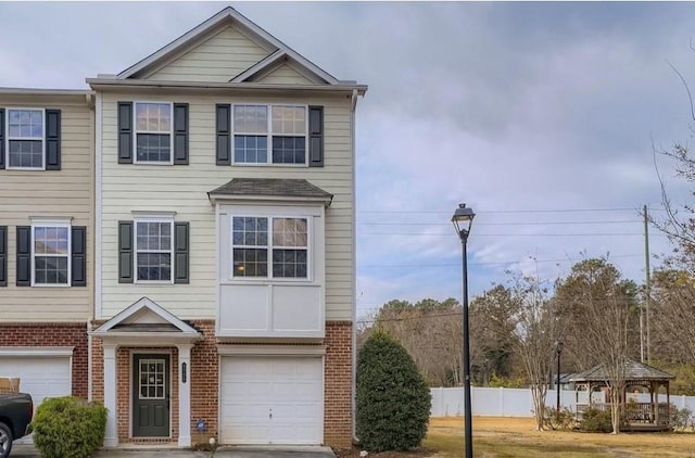 townhome / multi-family property featuring a garage and a gazebo