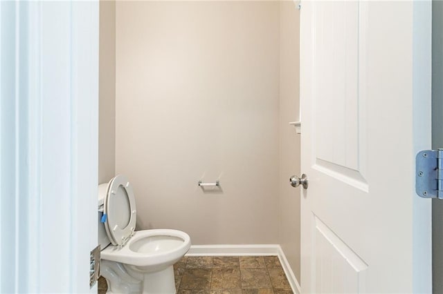 bathroom featuring toilet and baseboards