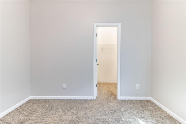 unfurnished room with carpet floors and baseboards