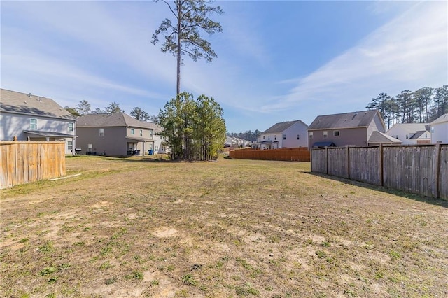 view of yard featuring a residential view and fence