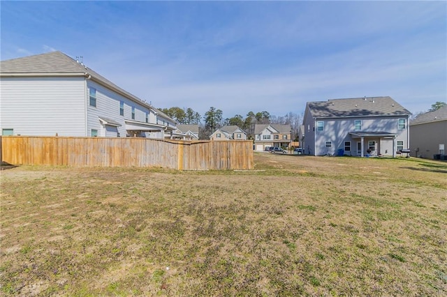 view of yard with a residential view and fence