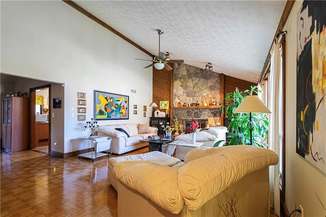 living room featuring wood walls, high vaulted ceiling, ceiling fan, parquet flooring, and a fireplace