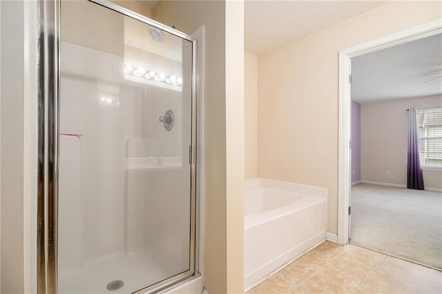 3262 Cascade Parc Blvd, Atlanta, GA 30311 - full bathroom featuring a shower stall, a garden tub, tile patterned floors, and baseboards
