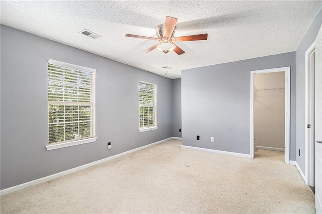 3262 Cascade Parc Blvd, Atlanta, GA 30311 - unfurnished bedroom featuring a textured ceiling, carpet flooring, baseboards, a ceiling fan, and a spacious closet