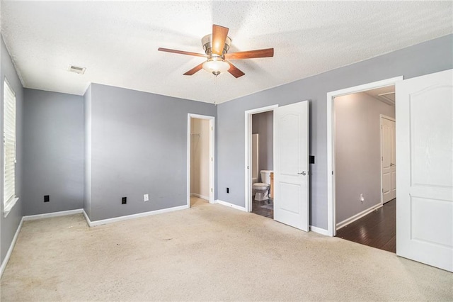 3262 Cascade Parc Blvd, Atlanta, GA 30311 - unfurnished bedroom featuring carpet flooring, baseboards, ensuite bath, multiple windows, and a textured ceiling