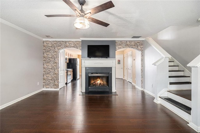 3262 Cascade Parc Blvd, Atlanta, GA 30311 - unfurnished living room featuring arched walkways, a ceiling fan, a textured ceiling, dark wood-style flooring, and crown molding