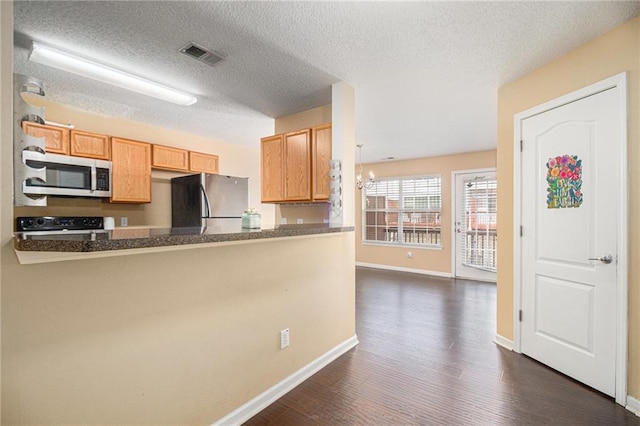 3262 Cascade Parc Blvd, Atlanta, GA 30311 - kitchen with freestanding refrigerator, stainless steel microwave, stove, baseboards, and dark wood-type flooring
