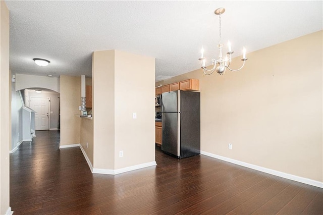 3262 Cascade Parc Blvd, Atlanta, GA 30311 - interior space featuring freestanding refrigerator, arched walkways, dark wood-style floors, a chandelier, and baseboards