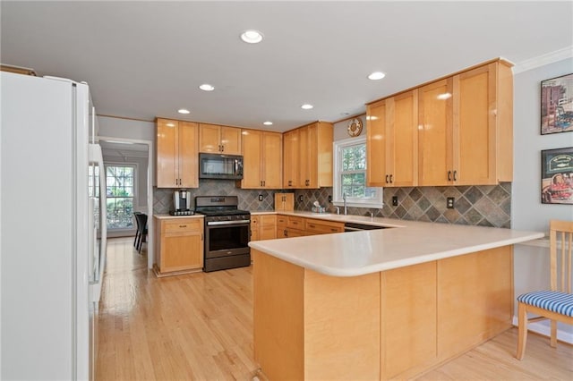 4423 Windsor Oaks Cir, Marietta, GA 30066 - kitchen with stainless steel range with gas stovetop, black microwave, freestanding refrigerator, light wood-type flooring, and recessed lighting