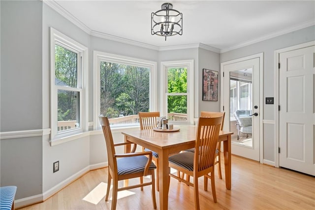 4423 Windsor Oaks Cir, Marietta, GA 30066 - dining room featuring plenty of natural light, light wood-type flooring, a chandelier, baseboards, and ornamental molding