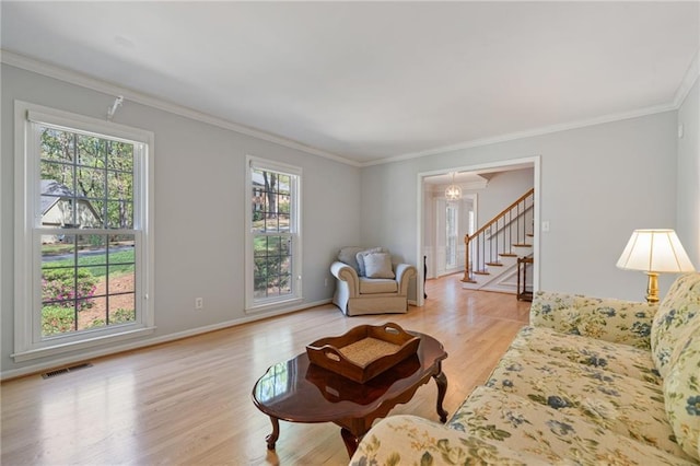 4423 Windsor Oaks Cir, Marietta, GA 30066 - living area with plenty of natural light, light wood-style flooring, stairs, crown molding, and baseboards