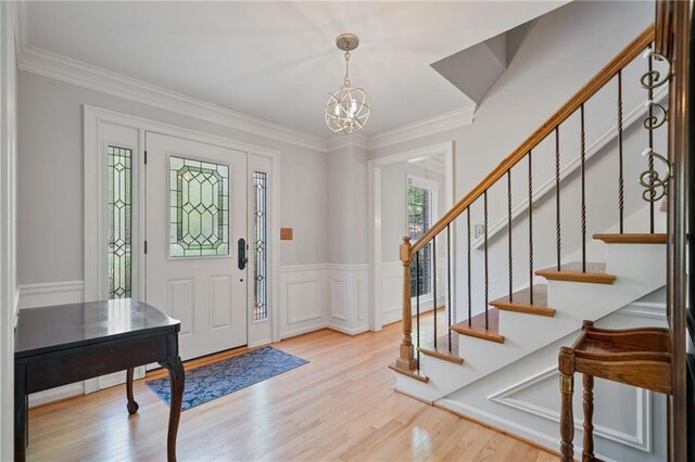 4423 Windsor Oaks Cir, Marietta, GA 30066 - foyer entrance with a chandelier, wood finished floors, stairs, and ornamental molding