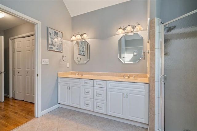 4423 Windsor Oaks Cir, Marietta, GA 30066 - full bathroom featuring double vanity, a shower stall, tile patterned flooring, and baseboards