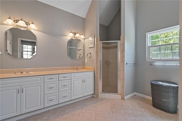 4423 Windsor Oaks Cir, Marietta, GA 30066 - bathroom featuring double vanity, a stall shower, lofted ceiling, tile patterned flooring, and baseboards