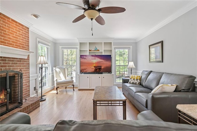 4423 Windsor Oaks Cir, Marietta, GA 30066 - living room with ornamental molding, light wood-style flooring, a fireplace, and ceiling fan