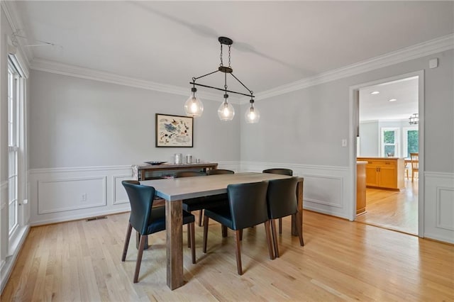 4423 Windsor Oaks Cir, Marietta, GA 30066 - dining area featuring light wood finished floors, crown molding, and wainscoting