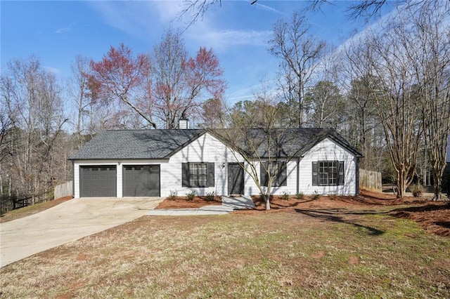 view of front facade featuring a garage and a front lawn