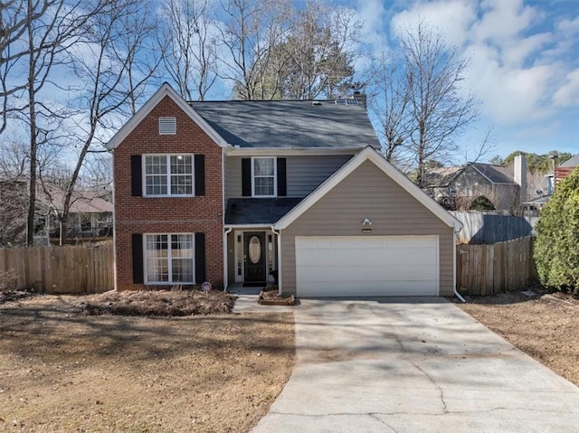 traditional-style home featuring concrete driveway, brick siding, fence, and an attached garage