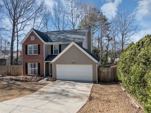 view of front of house featuring a garage, driveway, a chimney, and fence