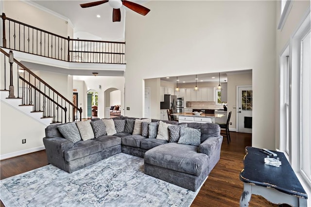 410 Hickory Fairway Ct, Woodstock, GA 30188 - living area featuring ceiling fan, dark wood finished floors, a towering ceiling, arched walkways, and stairway