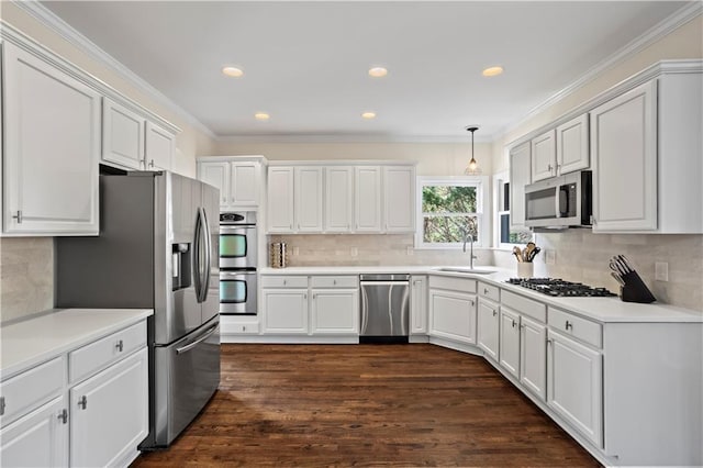 410 Hickory Fairway Ct, Woodstock, GA 30188 - kitchen featuring appliances with stainless steel finishes, a sink, decorative backsplash, white cabinets, and ornamental molding