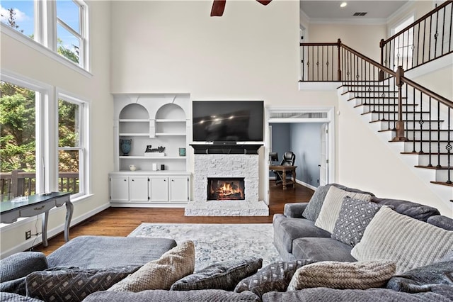 410 Hickory Fairway Ct, Woodstock, GA 30188 - living area featuring a high ceiling, a fireplace, wood finished floors, stairs, and a ceiling fan