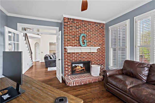 410 Hickory Fairway Ct, Woodstock, GA 30188 - living room with wood finished floors, stairway, a fireplace, arched walkways, and ornamental molding
