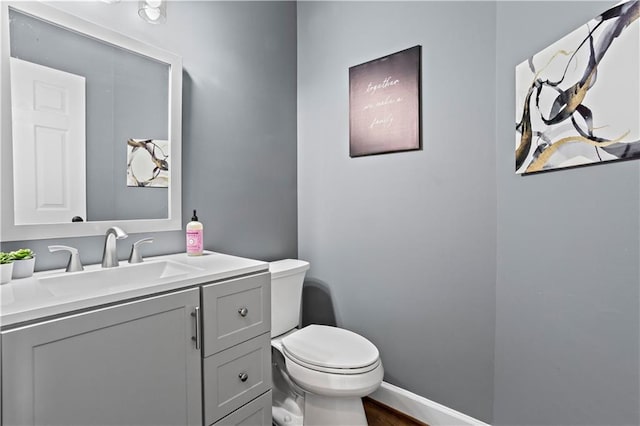 410 Hickory Fairway Ct, Woodstock, GA 30188 - bathroom featuring toilet, vanity, wood finished floors, and baseboards