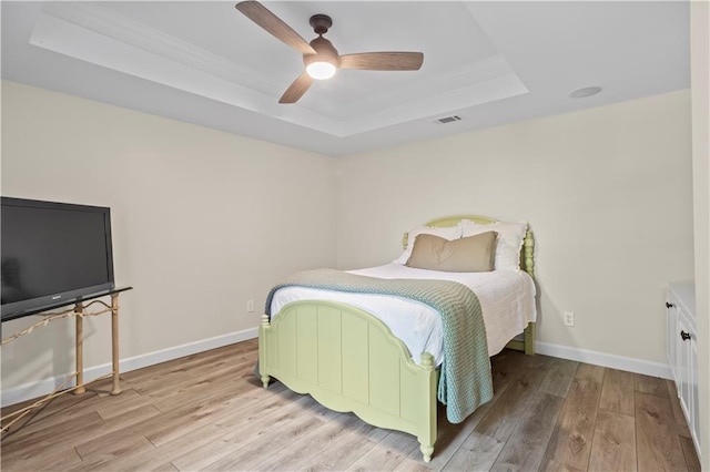 410 Hickory Fairway Ct, Woodstock, GA 30188 - bedroom featuring a tray ceiling, light wood-style floors, baseboards, and a ceiling fan