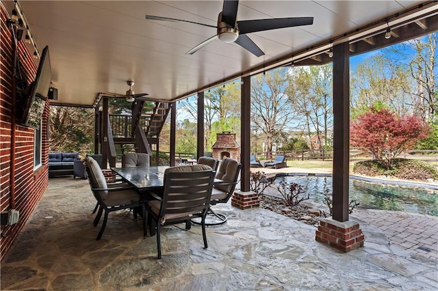 410 Hickory Fairway Ct, Woodstock, GA 30188 - view of patio with an outdoor stone fireplace, a ceiling fan, outdoor dining space, stairs, and an outdoor pool