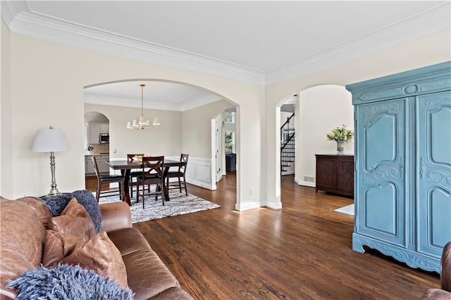 410 Hickory Fairway Ct, Woodstock, GA 30188 - living area featuring crown molding, dark wood-style floors, stairway, and arched walkways